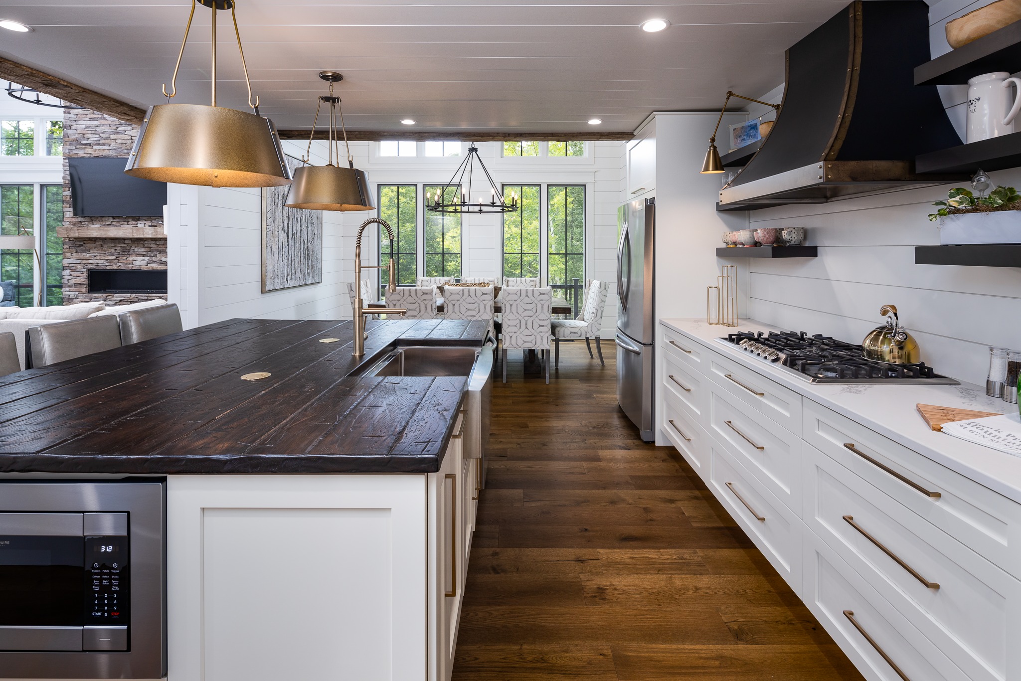 Custom kitchen with reclaimed wood island top and brass hardware