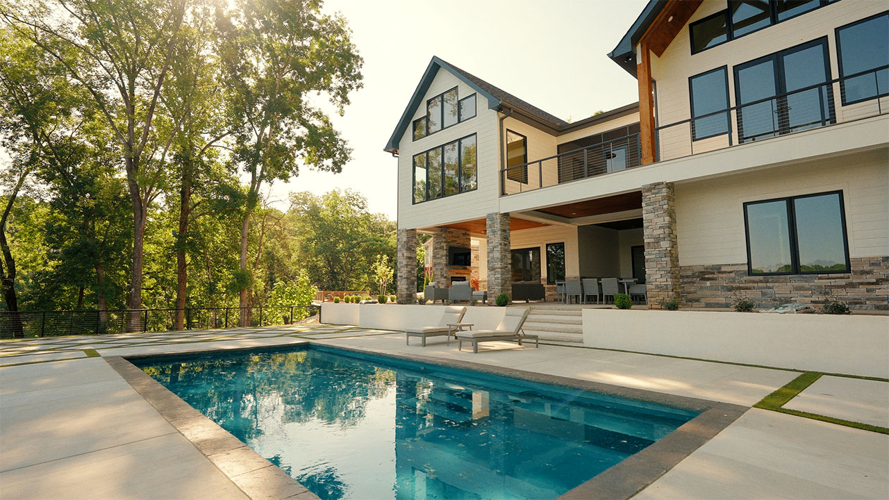 Pool and terraced patio behind a Baker Company custom home