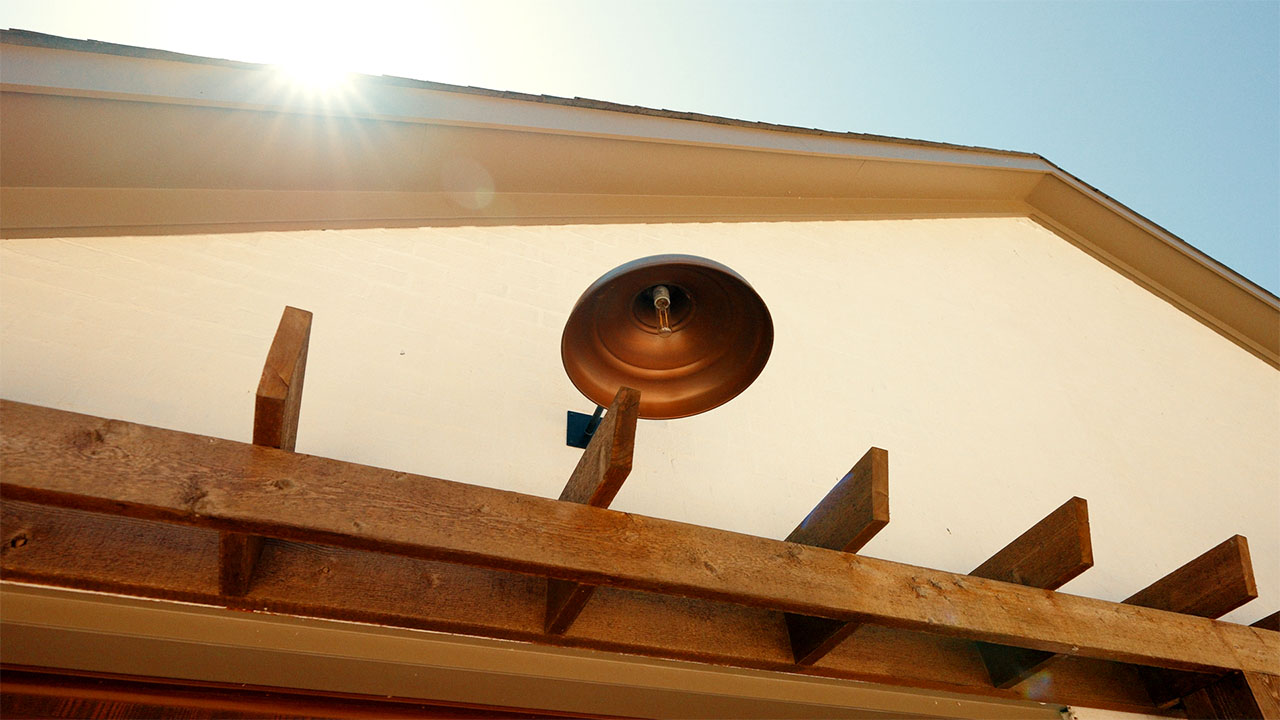 Copper barn light on a cedar pergola detail
