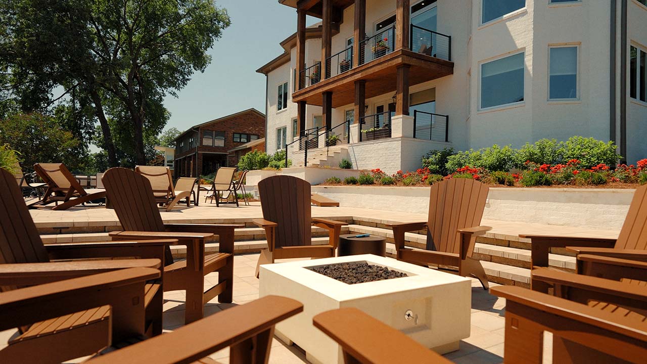 Fire pit terrace behind a lakeside home